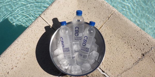 cbd living water bottle by the pool